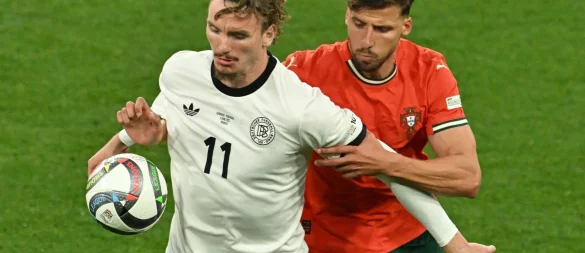 Nick Woltemade (l) hatte bei seinem Länderspiel-Debüt gegen Portugals Abwehrrecken einen schweren Stand. - © Peter Kneffel/dpa