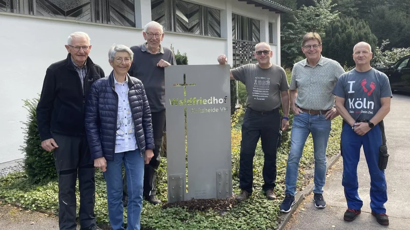 Die Vorstandsmitglieder Ralf Maluga, Gerold Knettermeier, Martin Kauer und Rainer Kasemeier freuen sich mit Marlis und Oswald Sch&auml;ffer (von rechts) &uuml;ber die neue Edelstahl-Stele vor der Kapelle. - &copy; Pro Waldfriedhof