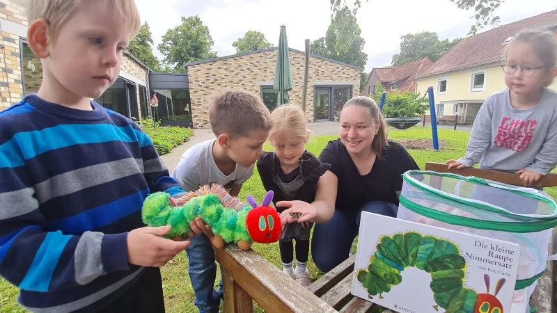 Die Kinder der katholischen Kita St. Joseph durften erleben, wie aus kleinen Raupen schöne Schmetterlinge werden. Erzieherin Katharina Möhring lässt mit (von links) Felix, Louis, Pauline und Karlie die Diestelfalter frei. - © Marianne Schwarzer