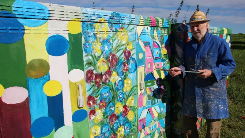 Der K&uuml;nstler h-Punkt-Schmidt mit den von ihm gestalteten Stromk&auml;sten. - &copy; Reinhold S&ouml;lter