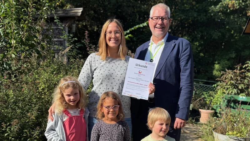 Judith Affeldt von der Kita Wilde Wiese und Stiftungsgeschäftsführer Christian Ritterbach freuen sich mit Kindern der Frösche-Gruppe. - © Gesundheitstiftung Lippe