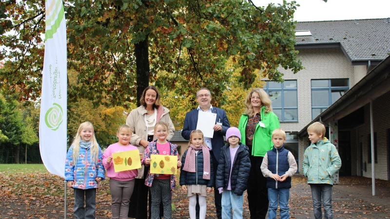 Regierungspräsidentin Anna Bölling (links) überreicht den Förderbescheid an den Vorsteher des Zweckverbandes Naturparks Teutoburger Wald/Eggegebirge, Landrat Dr. Axel Lehmann und Naturpark-Geschäftsführerin Dörte Pieper. Mit ihnen freuen sich Erstklässler der grundschule am Sennerand. - © Naturpark Teutobuger Wald/Eggegebirge