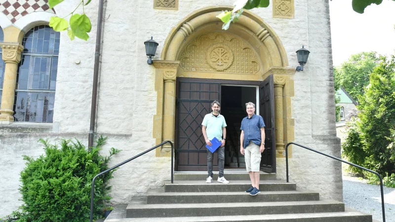 Kirchenführer Klaus Schuler (links) und Pastor Stefan Weise vor dem Portal der Helpuper Kirche. Foto: Gunter Held - © Gunter Held