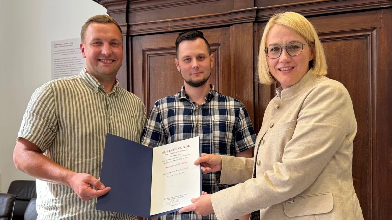 Mirko Ortmann (links) hat Sven B&ouml;ker (Mitte) nach einem schweren Unfall das Leben gerettet. Osnabr&uuml;cks Oberb&uuml;rgermeisterin Katharina P&ouml;tter &uuml;berreichte Ortmann daf&uuml;r eine Belobigung des Nieders&auml;chsischen Innenministeriums. - &copy; Stadt Osnbar&uuml;ck