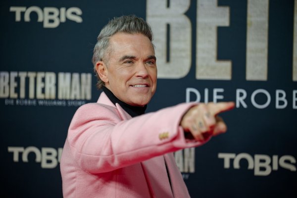 Robbie Williams kommt winterlich gekleidet zur Deutschland-Premiere seines Biopics. - © Henning Kaiser/dpa