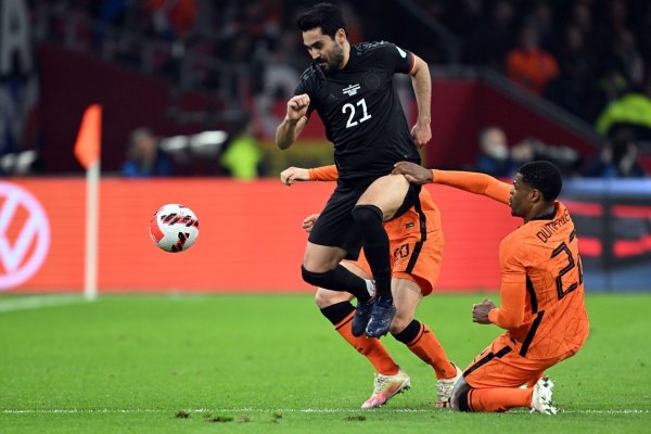 Deutschlands Ilkay Gündogan im Zweikampf mit zwei Niederländern. - © Federico Gambarini/dpa