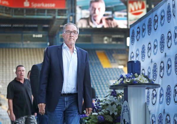 DSC-Präsident Hans-Jürgen Laufer neben der Urne von Lothar Buttkus. Auf dem Stadionschirm das Porträt des Stadionsprechers. - © Sarah Jonek