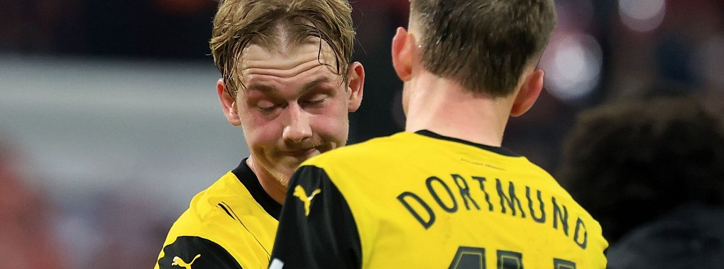 Julian Brandt (l.) und Maximilian Beier sind nach der Niederlage enttäuscht. - © Jan Woitas/dpa