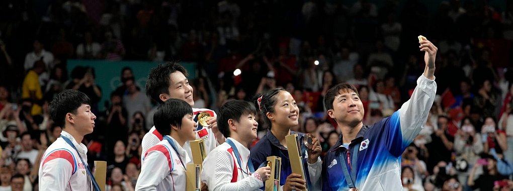 Ein Selfie für die Ewigkeit: Nord- und Südkoreaner bei Olympia mit dem chinesischen Team, - © Petros Giannakouris/AP/dpa