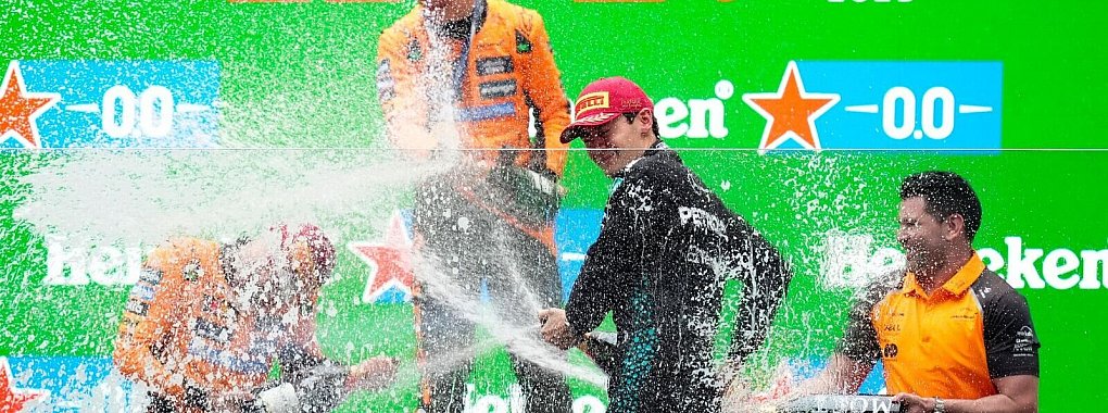 Champagner-Party ohne Verstappen: Die McLaren-Piloten Oscar Piastri und Lando Norris feiern mit Mercedes-Fahrer George Russell. - © Uncredited/AP/dpa