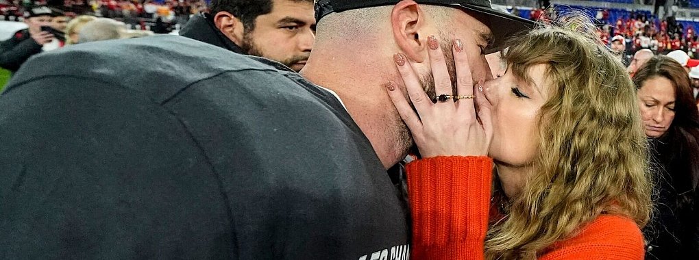 Ein Kuss f&uuml;r den AFC-Champion: Nach dem Sieg gegen die Baltimore Ravens holt sich Travis Kelce einen Kuss von Freundin Taylor Swift ab. - &copy; Julio Cortez/AP/dpa