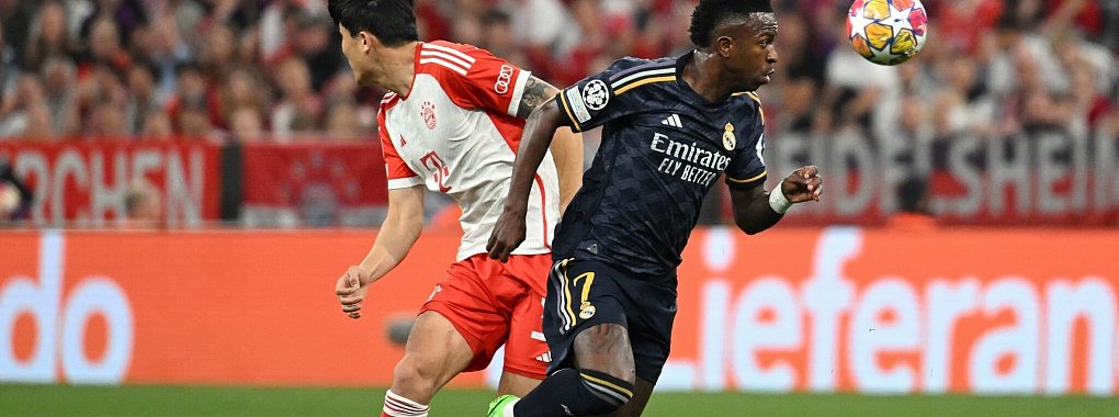 Bayern-Verteidiger Minjae Kim (l) war gegen Real-St&uuml;rmer Vinicius Junior teilweise &uuml;berfordert. - &copy; Sven Hoppe/dpa