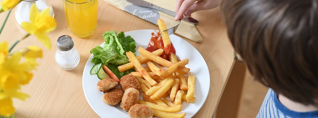 Chicken Nuggets mit Pommes: Im Restaurant kann der Wirt selbst entscheiden, ob er ein Kindergericht auch Erwachsenen anbietet. - © Tobias Hase/dpa/dpa-tmn
