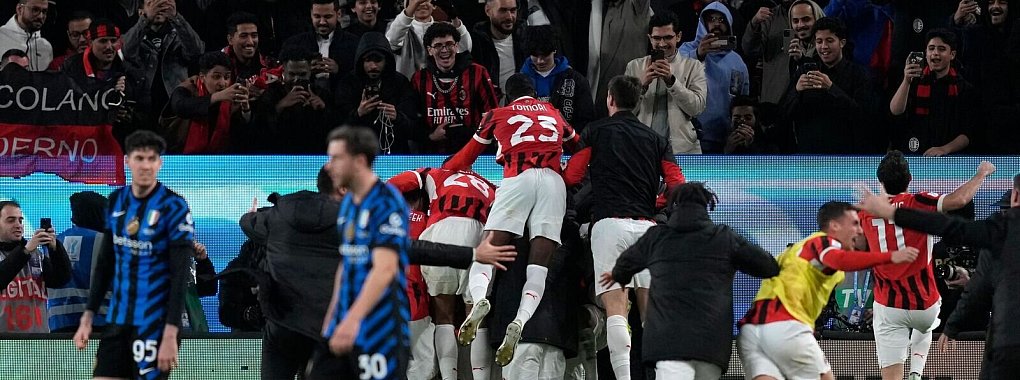 Die Milan-Spieler jubeln über den Siegtreffer. - © Altaf Qadri/AP/dpa