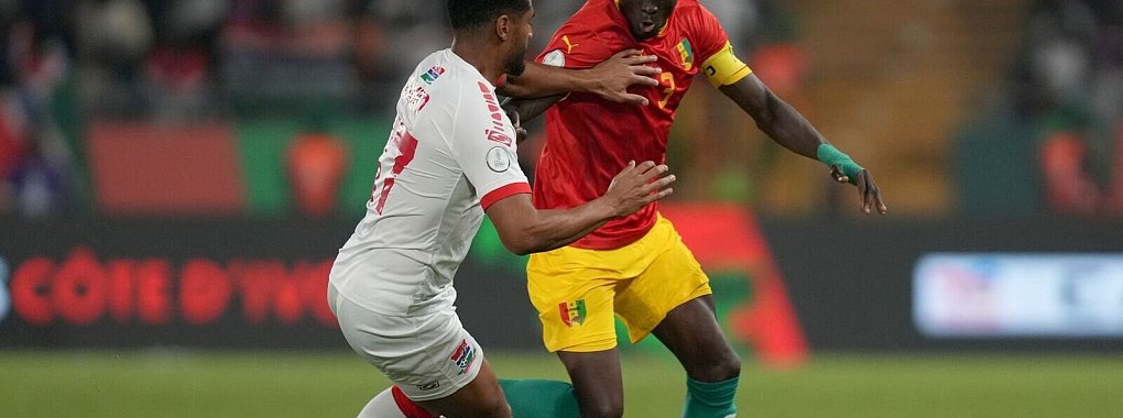 Guineas Issiaga Sylla (r) im Zweikampf mit Gambias Saidy Janko. - © Sunday Alamba/AP