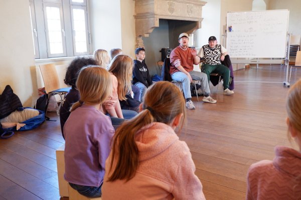 Leonard Ottolien gibt den Kindern den Takt vor. Gemeinsam mit Bruder Jonas hat er den dreitägigen Songwriting Workshop auf der Burg Sternberg geleitet. Am letzten Tag stoßen auch die Kinder der Musikfreizeit zum gemeinsamen Musizieren hinzu. - © Lorraine Brinkmann