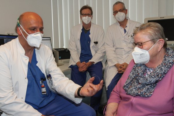 Oberarzt Dr. Dirk-Udo Härtel erklärt Erna Schweda, wie die Spange funktioniert, die nun dafür sorgt, dass ihre Herzklappe besser schließt. Oberarzt Dr. Johannes Brockmeyer (hinten links) und Chefarzt Dr. Stephan Gielen hören zu. - © Martin Hostert(LZ)