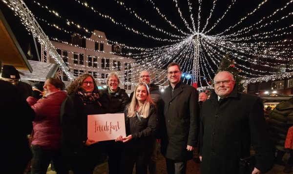 Daniela Stüker (von links, Gemeindepädagogin der evangelisch-reformierten Kirche), Pfarrerin Birgit Schneider, Stadtmarketingmitarbeiterin Lea Pommerenk, Christian Fischer (Evangelische Freikirchliche Gemeinde), Bürgermeister Matthias Kalkreuter und Jürgen Hülseweh (Katholische Kirche) haben den runderneuerten Weihnachtsmarkt in Lage eröffnet. - © Astrid Sewing