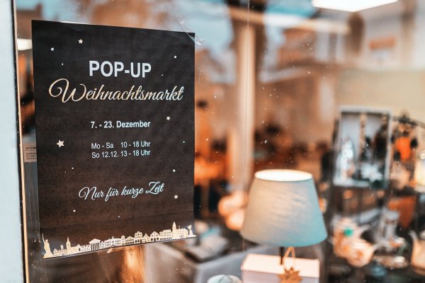 Das Plakat zum Pop-Up Weihnachtsmarkt im Schaufenster des Ladenlokals am Detmolder Marktplatz. - © Torben Gocke
