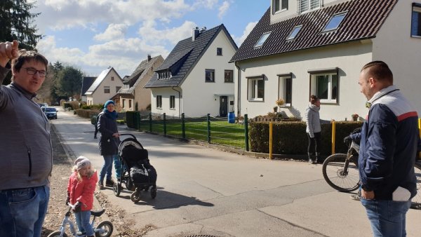 Manuel Tünker (von links) steht zusammen mit Silke Schirrmacher, Katja Friesen und Mario Mannel an der Ecke Grenzstraße / "Auf derm Papierkamp". Hier könnten Poller installiert werden. Im Hintergrund sind die Elterntaxis zu sehen, die auf dem Gehweg stehen. - © Nadine Uphoff