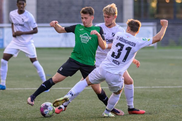 Oelringhausens Kapitän Daniel Nadig (grünes Trikot), hier im Duell mit zwei Rödinghauser Gegenspielern beim Pokalspiel, erzielte in der Meisterschaft gegen Paderborn das sehenswerte Tor zum 2:1. - © Egon Penner
