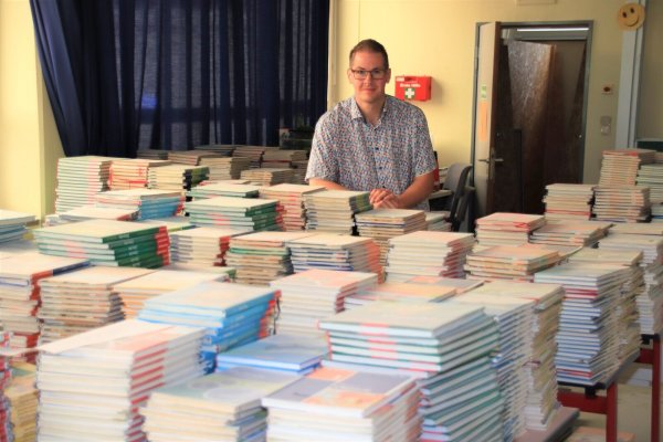 Der zweite Konrektor der Realschule Steinheim, Philip Peter, zeigt den feinen weißen Staub auf allen Büchern. - © David Schellenberg