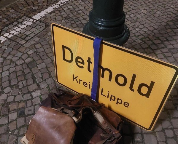 Morgens um kurz nach sechs Uhr am Bahnsteig in Detmold. Mit dem Ortsschild im Gepäch geht es quer durch NRW. - © Janet König