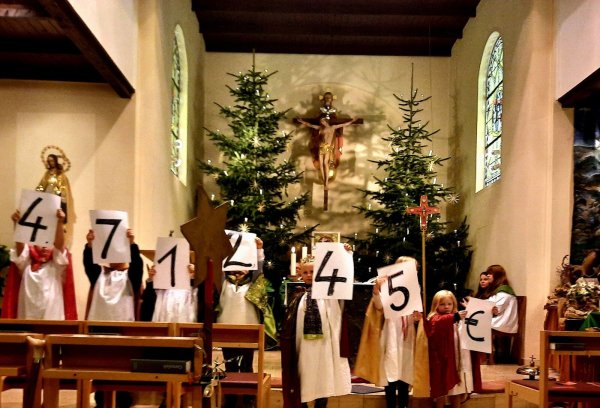 Stolz präsentiert ein Teil der diesjährigen Sternsinger die vorläufige Spendensumme. - © Madeleine Biermann