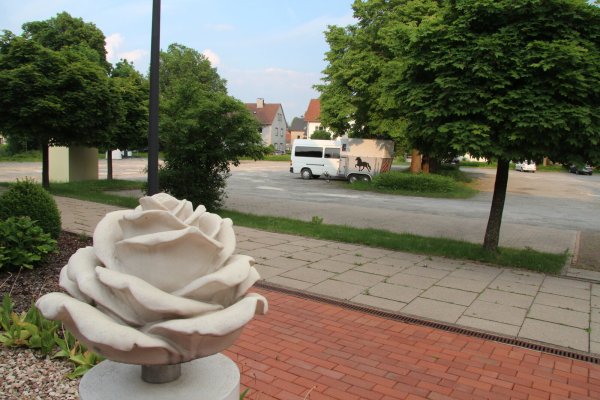 Der geschotterte Parkplatz an der Kampstraße – hier der Blick von der Tortenkonditorei aus – ist Teil der Fläche, auf der das Fachmarktzentrum realisiert werden soll. Das Areal soll größtenteils von transparenten Lärmschutzwänden umgeben sein. - © Dieter Asbrock