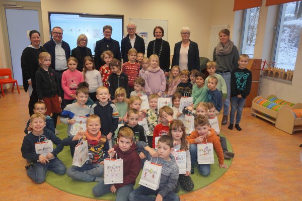 Katrin Paas (hinten von links, Stiftung "Für Lippe), Alfred Westermann (Buchhaus am Markt), Sabine Husemann-Seidel (Meyer-Sickendiek-Stiftung), Dr. A. Heinrike Heil (Stiftung Standortsicherung Kreis Lippe), Rainer Giesdorf (Stiftung "Für Lippe), Doris Böddeker (Buchhandlung Kafka & Co.), Ute Bicker (Schulamt Kreis Lippe) und Constanze Schmitz (Konrektorin Kusselberg-Schule) gemeinsam mit den Kindern der Klasse 1a und 2a bei der Übergabe der Lesetüten. - © Michaela Weiße