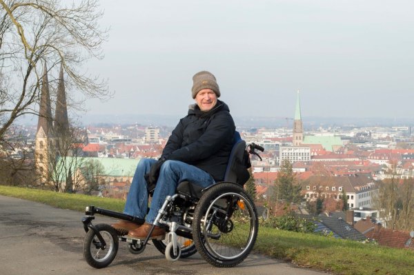 Matthias Klei ist mit seinem neuen Rollstuhl gerne in Bielefeld unterwegs. Der Weg zur Sparrenburg ist kein Problem für den 54-Jährigen und seine Assistenten. - © Alina Siepe