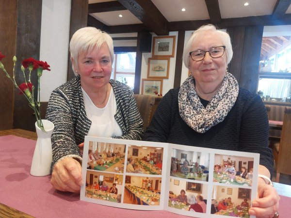 Hannelore Kreylos (rechts) wird die Leitung des Seniorentreffs im Februar nächsten Jahres an Annegret Peterseim abgeben. Die beiden Frauen zeigen Fotos der Seniorennachmittage. - © Michaela Weiße