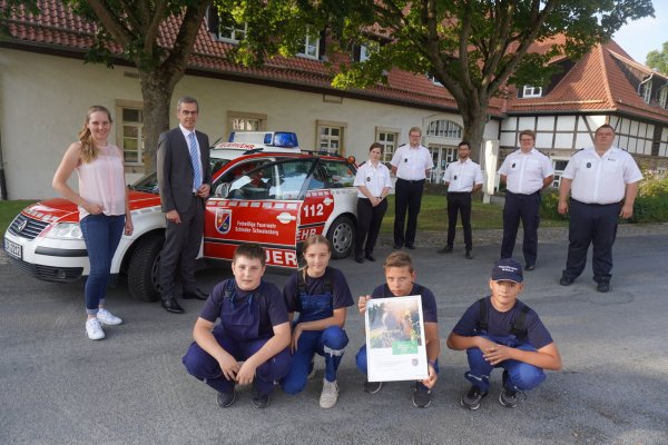 Westenergie-Kommunalmanagerin Maria Kemker (von links) und Bürgermeister Jörg Bierwirth zeichnen die Jugendfeuerwehrgruppe aus Wöbbel mit dem Klimaschutzpreis aus. Diesen nehmen Fynn (vorne von links), Gina, Nik und Marvin entgegen. Mit ihnen freuen sich Mike Mundhenke (hinten von rechts), Leiter der Freiwilligen Feuerwehr, sowie Laurenz Meier, Till Wascher, Lukas Meier und Manuela Galsterer (alle Löscheinheit Wöbbel). - © Michaela Weiße(LZ)