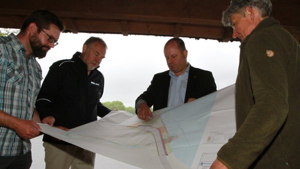 So soll der Norderteich auf Dauer gesichert sein (von links): Daniel Telaar, Olrik Meyer (Kreis Lippe), Arne Brand und Susanne Hoffmann (Landesverband) mit dem Plan zu Stabilisierung des Damms. - © Martin Hostert
