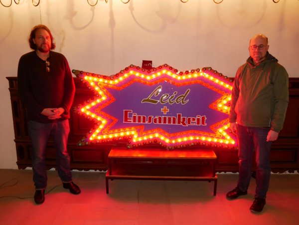 "Leid und Einsamkeit". Die Licht-Installation von Jan Philip Scheibe (links) stellt einen Kontrapunkt zur "Judensau" dar und erinnert an das Novemberpogrom 1938. Rechts im Bild steht Matthias Altevogt. - © Thomas Krügler