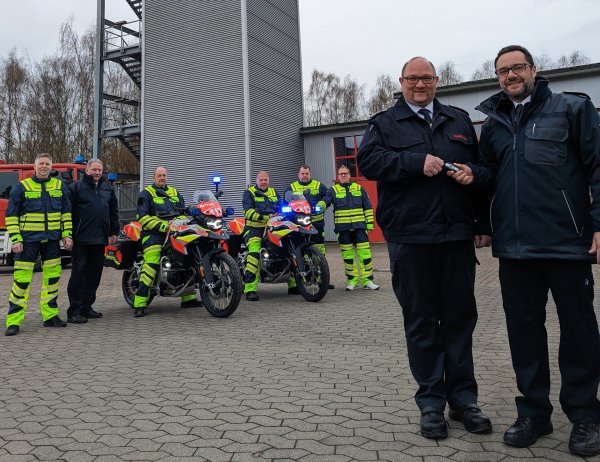 In Lippe im Einsatz: Sascha Medina (vorne rechts) übergibt Marco Gröne die Schlüssel für die neuen Kräder. Kreisbrandmeister Wolfgang Kornegger (hinten, Zweiter von links) freut sich mit Detlef Limpke, Emil Hein, Mario Trompeter, Mike Bartels und Ingo Büschemann (von links), die künftig auf den Motorrädern unterwegs sein werden. - © Kreis Lippe