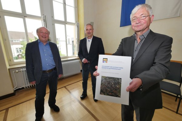 Norbert Priesel (links) und Dr. Gerhard Stemmler (rechts) übergeben im Ratssaal den Jahresbericht der Gruppe „Immobilien & Stadtentwicklung" im Bürgerdialog an Bürgermeister Heinz-Dieter Krüger. - © Jost Wolf