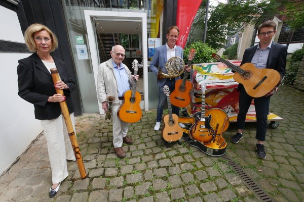 Christina Haberbeck (von links), August Nagel, Kay Sandmann-Puzberg und Maik Huebner von der Bürgerstiftung zeigen gespendete Instrumente. Im Hintergrund steht das Detmold-Klavier. - © Jost Wolf