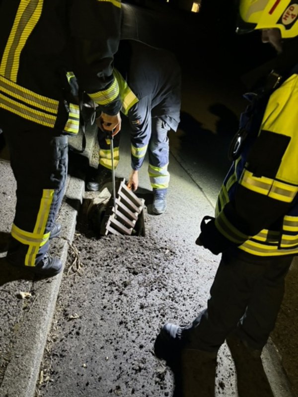 Einsatzkräfte begutachten letzten Freitag einen Gullydeckel in Vlotho. - © -/Feuerwehr Vlotho/dpa