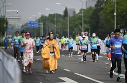 Manche hatte sich für den Lauf traditionelle Gewänder angezogen. - © Johannes Neudecker/dpa