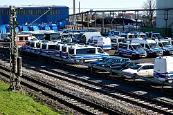 Zahlreiche Einsatzfahrzeuge stehen an der Bahnstrecke am Hafen. - © Sina Schuldt/dpa