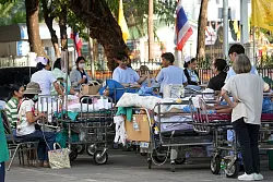 Patienten aus vielen Krankenhäusern wurden in Bangkok schnell ins Freie transportiert. - © Sakchai Lalit/AP/dpa
