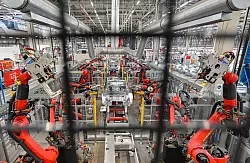 Roboter verschwei&szlig;en die Karosserie eines Elektrofahrzeuges vom Typ Model Y. - &copy; Patrick Pleul/dpa