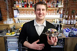 Ihm kann es nicht zu bunt sein: Bozzato bereitet den kunstvollen Milchschaum im Kaffee im Familienbetrieb zu. - &copy; Daniel Karmann/dpa