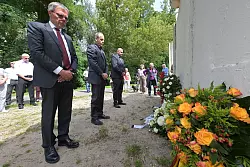 Potsdams Bürgermeister Burkhard Exner (SPD, l-r), Groß Glienickes Ortsvorsteher Winfried Sträter und Berlins Spandaus Bürgermeister Frank Ewig (CDU) gedenken an einem alten Stück Berliner Mauer, das ein Teil der Mauergedenkstätte im Gutspark Groß Glienicke ist, an den Mauerbau. - © Michael Bahlo/dpa