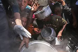 Palästinenser erhalten Lebensmittel in Beit Lahia. - © Jehad Alshrafi/AP/dpa