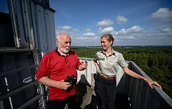 Feuerwächter Rudolf Hoffmann im Gespräch mit Försterin Carla Paul auf dem Feuerwachturm Galgenberg in Nordrhein-Westfalen. - © Henning Kaiser/dpa