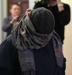 Eine Zeugin verl&auml;sst vermummt den Gerichtssaal. - &copy; Marcus Brandt/dpa