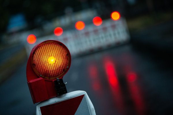 Eine Warnleuchte steht an einem abgesperrten Bereich auf einer Straße. - © Swen Pförtner/dpa/Symbolbild