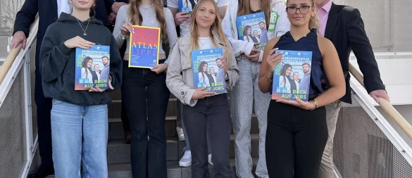 IHK-Abteilungsleiter Martin Raithel, IHK-Präsident Volker Steinbach (hinten, von links) und Schulleiter Dr. Jörg Weber (rechts) stellen zusammen mit Schülerinnen und Schülern des Wirtschaftsgymnasiums am Dietrich-Bonhoeffer-Berufskollegs in Detmold den neuen Ausbildungsatlas OWL vor. - © IHK Lippe